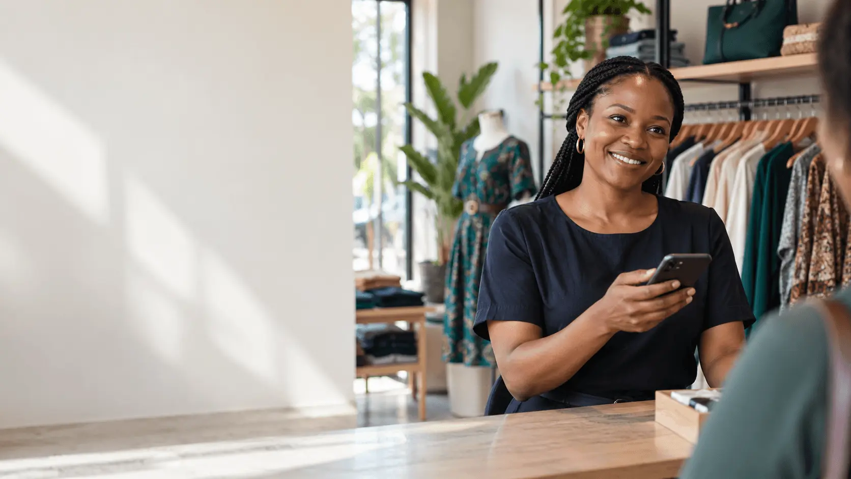 A boutique shopkeeper at the counter